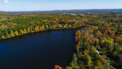 Aerial drone view of lake in autumn state park.