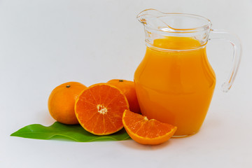 Orange juice in a glass jar Set on the table, white background
