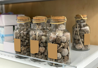 Glass jars with dried flowers on a shop window.