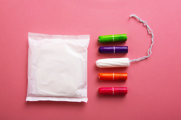 Medical female tampon on a pink background.