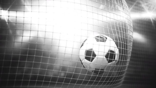 A soccer ball flies into the goal against the background of stands. 3d render. The effect of the old black and white shooting.