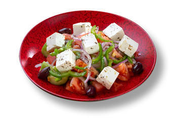Fresh salad with tomatoes and peppers in modern red plate