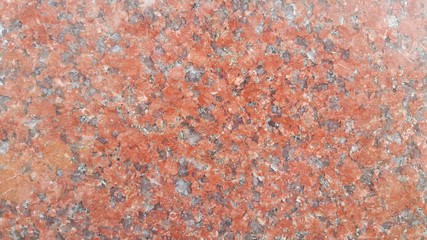 Closeup texture of red concrete floor. Background of a red concrete in sunshine