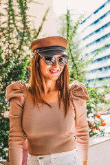 Attractive woman with long hair, hat and sunglasses. Fashion