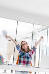 Businesswoman celebrating success in office