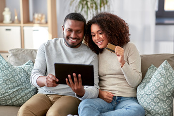 family, technology, online shopping and people concept - happy african american couple couple with...