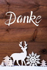 German Calligraphy Danke Means Thank You. Christmas Decoration Like Snowflake, Tree And Deer. Brown Wooden Background