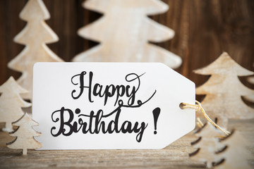 Label With English Text Happy Birthday. White Wooden Christmas Tree As Decoration. Brown Wooden...