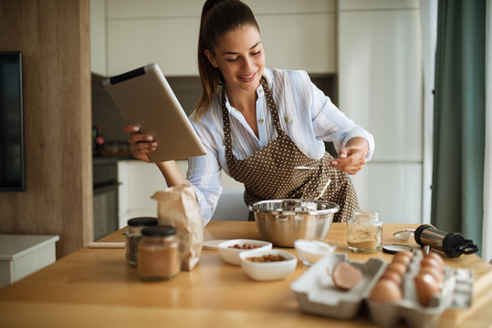 Young girl in the kitchen preparing cakes
