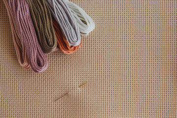 flatlay creativity: canva aida beige and multi-colored thread mouline thread, cross-stitch