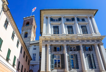 Facade of an old Italian building in old part of town, windows with shutters, old building in Genoa, Italy.