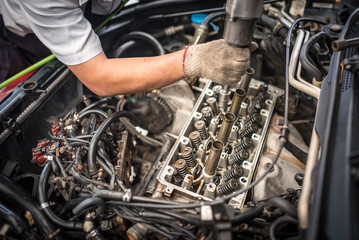 Fototapeta na wymiar Engine valve car maintenance. A deposit on a piston, a large run a long service life