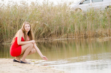young woman in red dress nature fresh air
