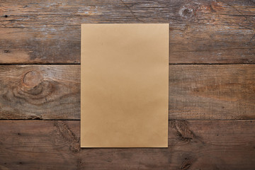 A wish list. Old paper sheet at grunge wooden background with copy space