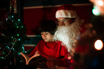 Santa clause reading tale for kid at christmas festival  at home,Thailand people