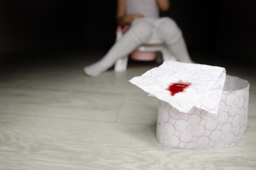 The child has stomach problems, he sits on the toilet, he has diarrhea, constipation or hemorrhoids. A child with pantyhose lowered sits on a pot and holds bloody toilet paper in his hands. Digestive 