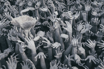 Hands sculptures in Wat Rong Khun, famous white temple in Chiang Rai, Thailand