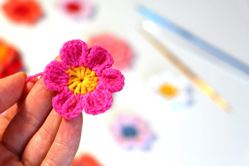 Needlework. Beautiful knitted flowers. Crochet.  Pink flowers.