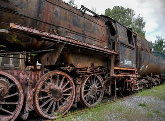 Fototapeta na wymiar dilapidated, rusty and abandoned steam locomotive