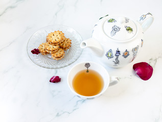 Afternoon tea with teapot and cookies