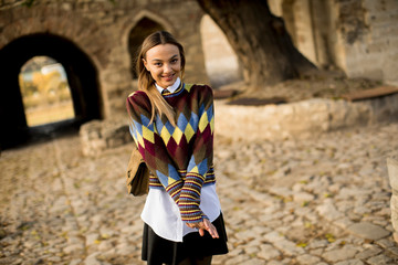 Young woman standing outside at sunny autumn day