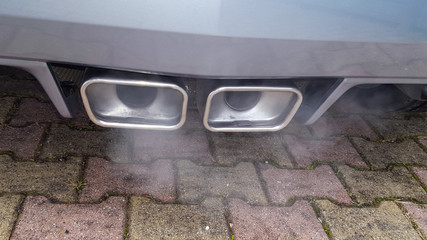 smoking sports car exhaust outlet