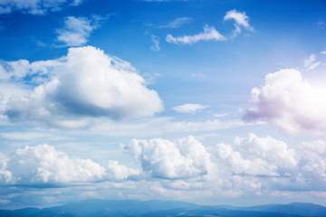 Fantastic view of the azure sky on a sunny day with fluffy clouds.
