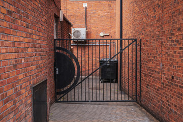 A closed gate in front of a backyard, seen in Carlisle, Cumbria, England, UK