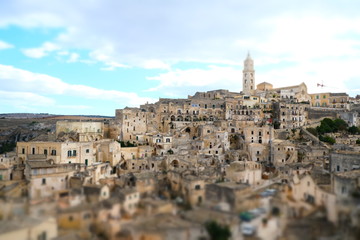 Obraz premium View of the city of Matera in Italy. Church with bell tower and houses built in beige tuff stone.