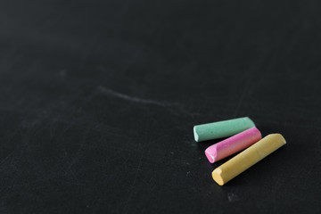 Chalks in a variety of colors on black background