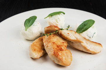 Grilled chicken breast with mozzarella cheese decorated with basil. Concept for a healthy meal.