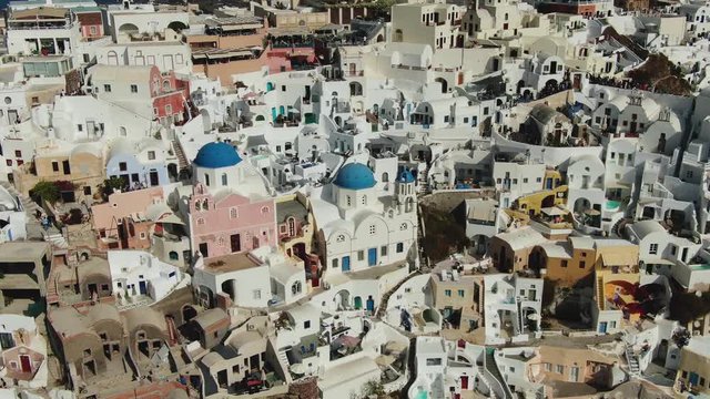 Flying Over Famous Blue Domed Church In Oia On Santorini Island In Greece