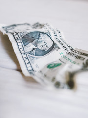 Financial crisis, bankruptcy. Wrinkled one dollar bill. White background.