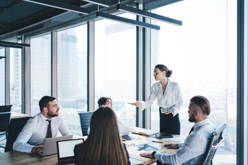 Female boss having briefing with staff