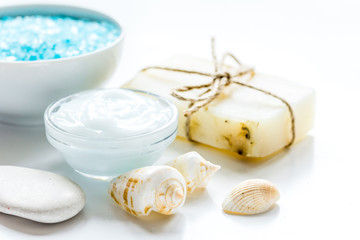 Obraz na płótnie Canvas blue set for bath with salt and shells on white table background
