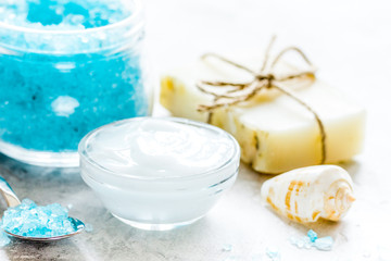 blue spa composition with blue sea salt and natural soap on stone desk background