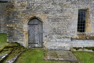 Fototapeta na wymiar detail of ancient wooden door in a medieval old stone building