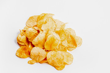 heap of fresh crunchy potato chips on white background
