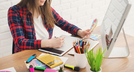 Creative designer working on a graphic tablet while using computer in office