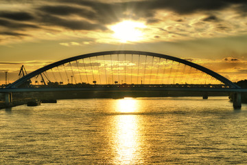 Fototapeta na wymiar Sunrise in Bratislava over Apolo bridge and Danube river, Slovakia