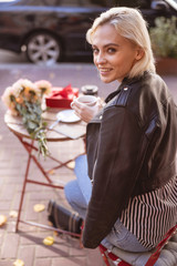 Happy woman having a coffee break alone