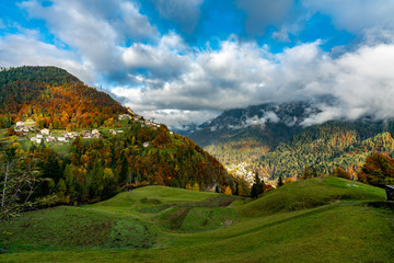 Colourful aumtumn picture across the Cordevole valley with Pecol and Piaia villages in the background