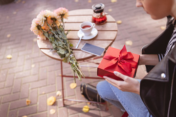 Woman going to open her birtday gift