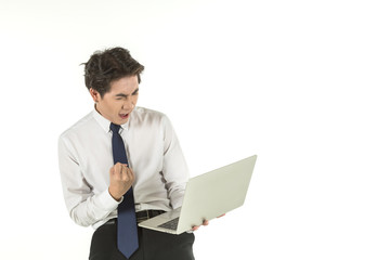 Portrait of smart young asian businessman wearing white shirt holding and looking to computer laptop clench one's fists and emotion glad on isolated white background and copy space.