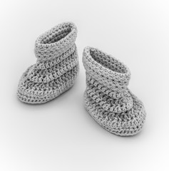 knitted baby booties on white