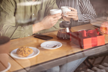 Young people enjoying their morning date in the cafe