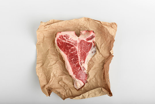 a piece of fresh farm meat t-bon non-GMO wrapped in eco-friendly wrapping paper
