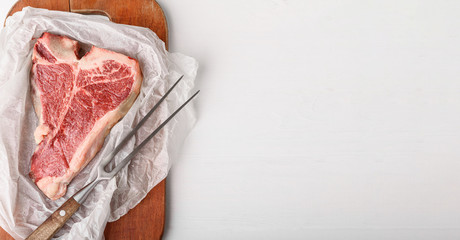 a piece of fresh farm meat t-bon non-GMO wrapped in eco-friendly wrapping paper