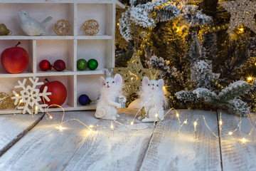 christmas tree with gifts and decorations and mice in front of house
