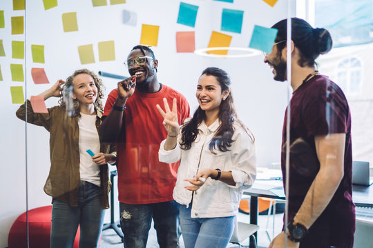 Laughing colleagues making plan of project